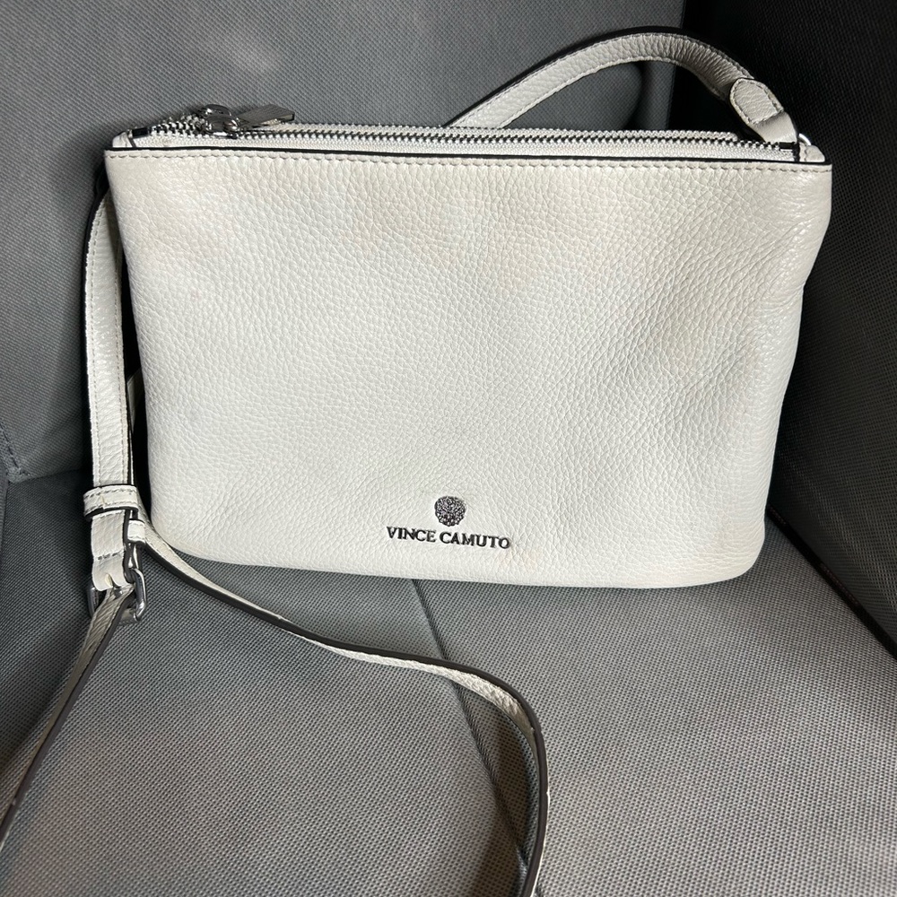 Vince Camuto cream leather crossbody with 2 zipper compartments.